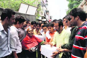 DAV PG College students beg as part of their protest in Dehradun on Saturday
