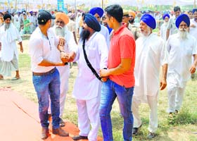 Voice of dissent: A protester, who raised anti-Hooda slogans during the convention, being taken away from the venue in Kaithal district on Sunday