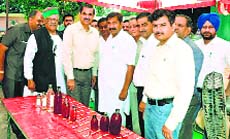 Industries Minister Mukesh Agnihotri and GIC officers at the launch of a new country liquor brand in Mehatpur on Sunday.