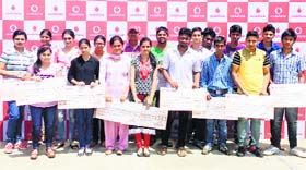Students with scholarship certificates awarded by Vodafone in Jammu.