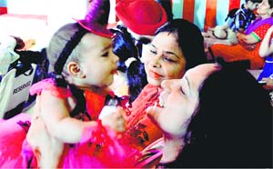  A mother with her baby during a fashion show at Mothers Pride Preschool.