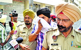 Rommy Uppal in police custody. A file photograph