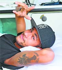 Brazil's star Neymar flashes the V sign before his departure for his home