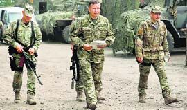 Newly-appointed Ukrainian defence minister Valery Heletey (centre) walks with troops at a base near Slavyansk on Sunday.