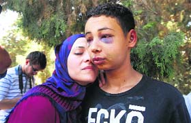 Tariq Khdeir (R) is greeted by his mother after being released from jail in Jerusalem on Sunday.