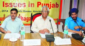 Labour Minister Chunni Lal Bhagat (centre) holds a meeting with industrialists in Amritsar on Monday.