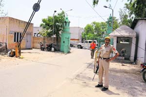 A security guard deployed at the main entrance of the Police Lines in Bathinda.