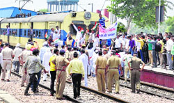 Angry Congress workers climb on to an engine at the Karnal station on Monday. Tribune photo: Ravi Kumar