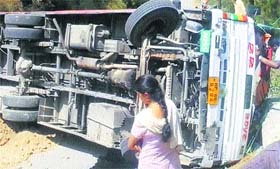 A bus overturned near Aut in Mandi on Monday.