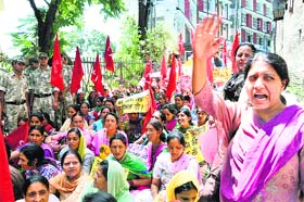 Activists of the Anganwari Union raise slogans during a demonstration at the Directorate of Women and Child Development Office in Shimla on Monday.