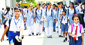 Students return to schools after summer vacation in Ludhiana on Monday.
