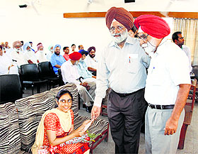 Punjab Agricultural University Vice-Chancellor Dr Baldev Singh Dhillon felicitates Inderjit Nandan during a function in Ludhiana on Monday.