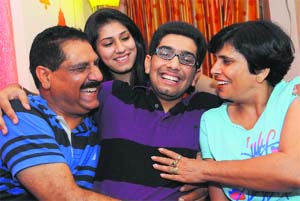 Ritwick Chaudhary, who scored the all-India rank 74 in the JEE (Mains), with his family at their residence in Sector 39, Chandigarh, on Tuesday.