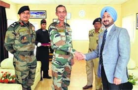 GOC-in-C of the Northern Command Lt Gen DS Hooda shakes hands with Deputy Commissioner Simrandeep Singh in Leh on Tuesday.