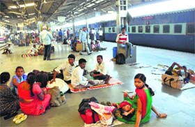 Passengers wait at the Jammu railway station on Tuesday.