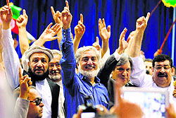 Afghan presidential candidate Abdullah Abdullah (C) waves to his supporters during a rally in Kabul on Tuesday