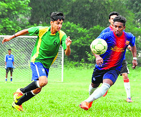 Players vie to take control of the ball during a match in the Ram Bahadur Chetri Memorial Football Tournament at the FRI ground in Dehradun on Wednesday.