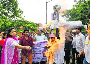 People burn an effigy of Trinamool Congress MP Tapas Pal during a protest over his controversial remarks in Kolkata