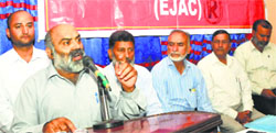 Jammu and Kashmir Government Employees Joint Action Committee President Ram Kumar (R) addresses a state-level convention in Srinagar on Wednesday. Tribune Photo: Amin War