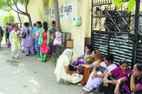 Teachers sitting outside the school as the protest goes on