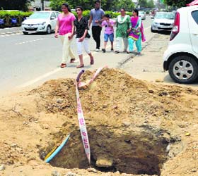 Traffic hazard: An open pit on the Mall road poses threat to commuters