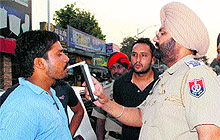 A traffic police official uses alcometer to check drunken driving in Amritsar