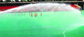 Water being sprinkled at the AstroTurf in the Sports Complex, Sector 42, Chandigarh, on Thursday.