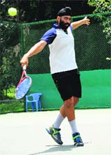 Brahmjot returns a shot during a semi-final match of the CLTA-AITA tennis tournament at the CLTA, Chandigarh, on Thursday.