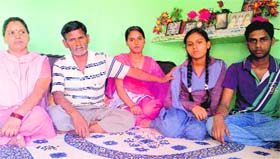 (L-R) Ramvati with her husband Ram Niwas and their children, Pooja, Aarti and Chandan at their residence in Abheypur village, Panchkula, on Thursday. 