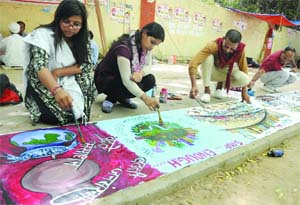  Artists make paintings on population under the banner of the Health Education and Environment Awareness Society on the eve of World Population Day at Jantar Mantar in New Delhi on Thursday.