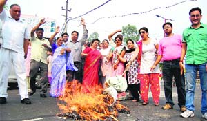 Congress activists protest weak economic policies of the NDA government in Haridwar on Thursday