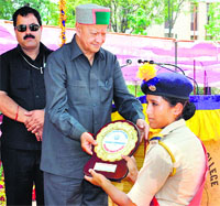 Chief Minister Virbhadra Singh honours a cadet at a Police Training Centre at Daroh near Palampur on Thursday. Photo: Ravinder Sood