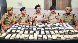 Uttam Chand, SSP, addresses mediapersons after cracking the robbery case in Jammu on Thursday.