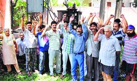 inhabitants of Hazuribagh protest against Power Development Department for not repairing the transformer of the area in Jammu on Thursday.