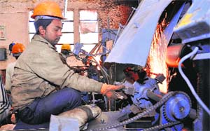 A labourer busy with his work at an industrial unit in Jalandhar.