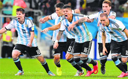The Argentina players rush in to celebrate the moment they shoot-out the Netherlands from the semifinal clash in Sao Paulo on Wedneday. AFP