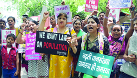 Members of Surbhi Pariwar Foundation, an NGO, raise slogans during a demonstration to creat awareness on the rising population on the occasion of World Population Day in Jantar Mantar in New Delhi on Friday. Delhi is worlds second most populous city.