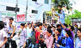 Students of MCM DAV College raise slogans at the college gate in Kangra on Friday.