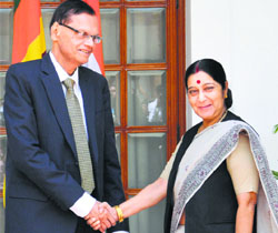 External Affairs Minister Sushma Swaraj shakes hands with her Sri Lankan counterpart Gamini Peiris in New Delhi on Friday.