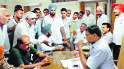 Farmers protest inside the Irrigation Department office in Abohar on Friday. Tribune photo