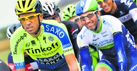 Spains Alberto Contador (L) rides in the pack during the 234.5 km seventh stage of the 101st edition of the Tour de France.