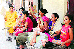 Residents are forced to sit out of their houses due to a power cut in Amritsar on Saturday