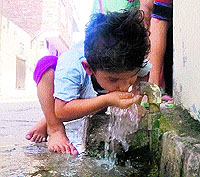 With temperature soaring in the city, a boy quenches his thirst from an open tap in a street in Amritsar on Saturday