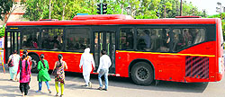 A city bus plying on a road in Amritsar