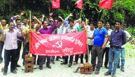 Workers of Om Power Project take out a procession in Palampur on Saturday.