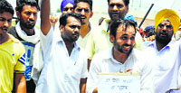 AAP MP from Sangrur Bhagwant Mann and his supporters protest against power cuts in Shehna town of Barnala on Saturday. Tribune photo