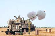 An Israeli mobile artillery unit fires towards Gaza on Saturday