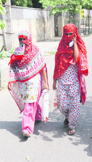 Women cover their faces to protect themselves from heat in Bathinda on Sunday