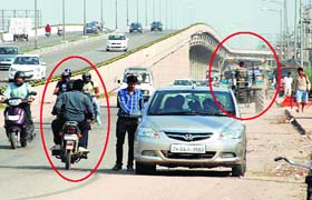 A two-wheeler and a tractor enter the wrong lane alongside the flyover on the Zirakpur-Chandigarh Highway in Chandigarh