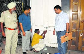 Officials of the Estate Office seal a building adjoining the NIELIT structure in Sector 17, Chandigarh, on Sunday
